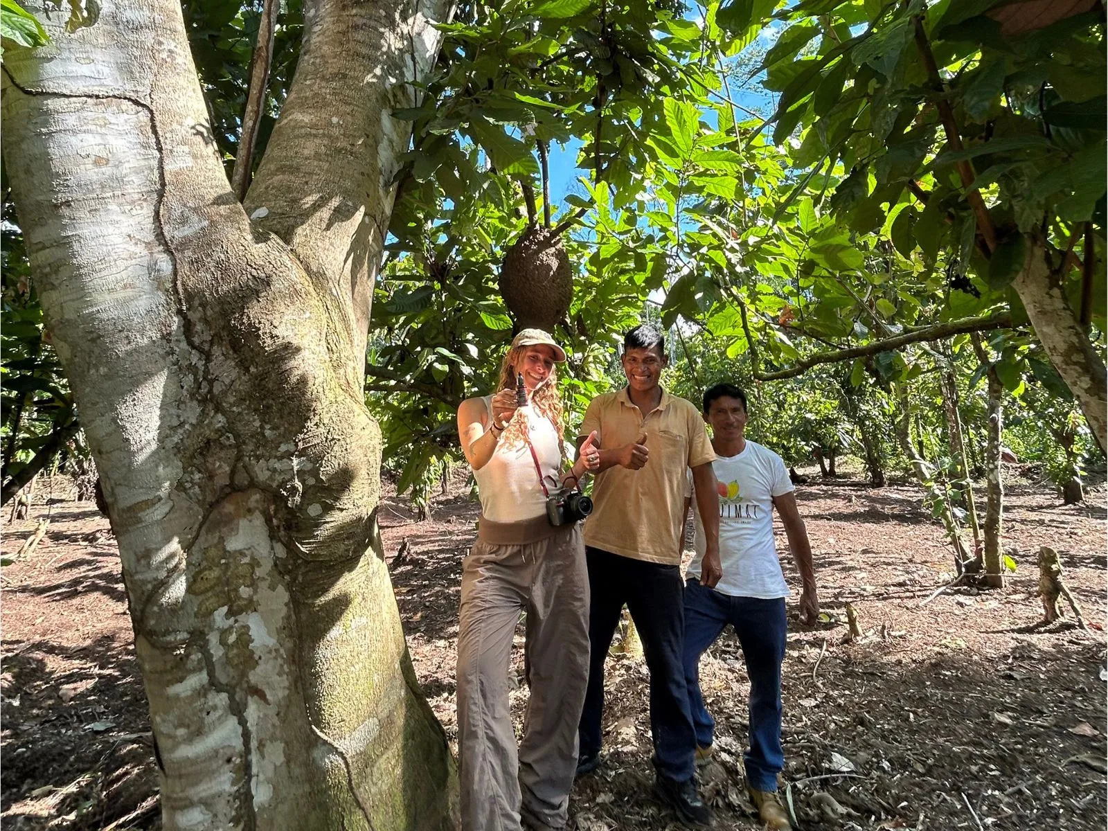 Valeria del Busto, Head of Sustainability at Amazon Andes, standing with local farmers near a Croton lechleri tree in Datem del Marañón